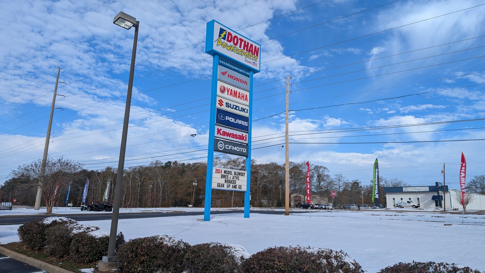 The pylon sign over a snow covered lot