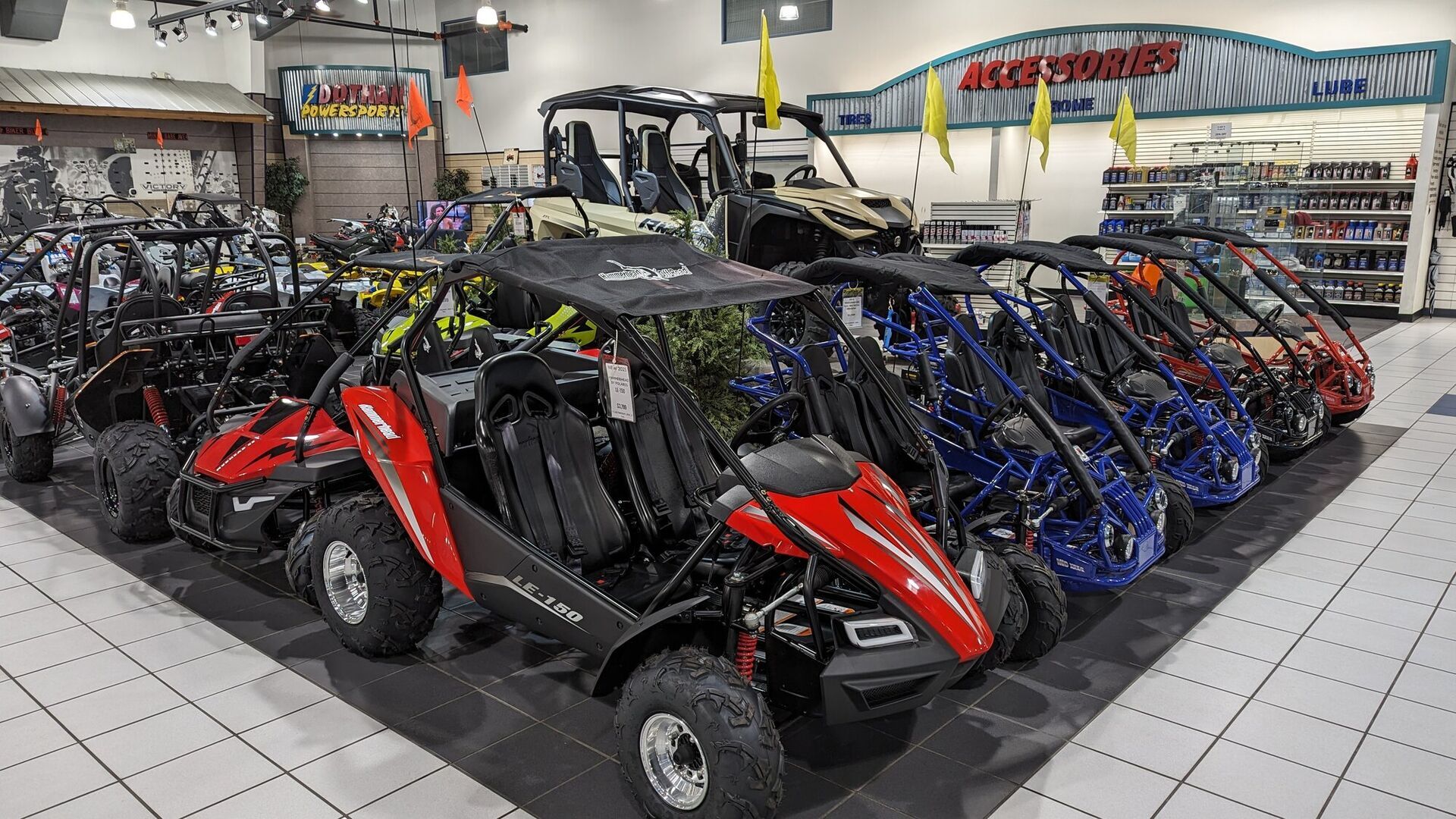 Youth UTVs in front of the accessories wall